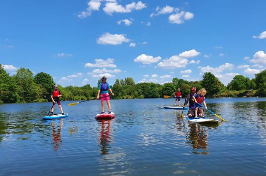 Stand up paddleboarding adults and children