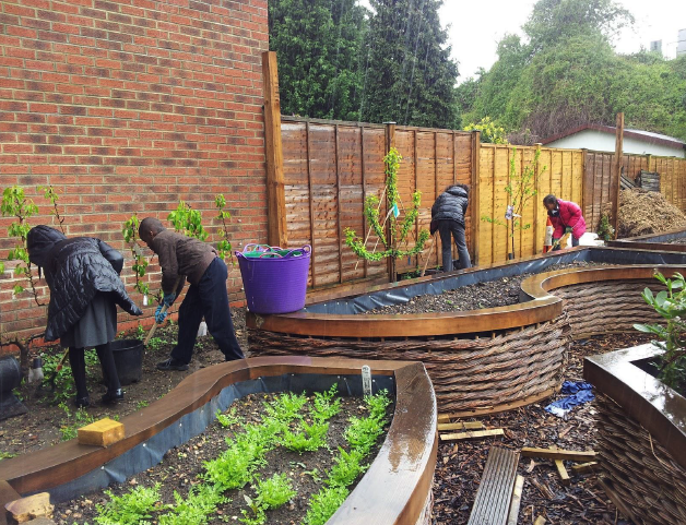 A picture of children working on Colette's secret garden as part of their outdoor learning programme in London